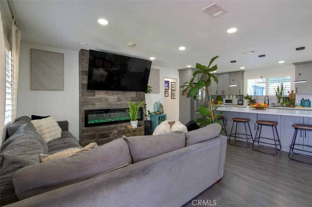 11523 Richeon Avenue Downey, CA 90241 - Photo 5 of 25 a living room with fireplace furniture and a flat screen tv