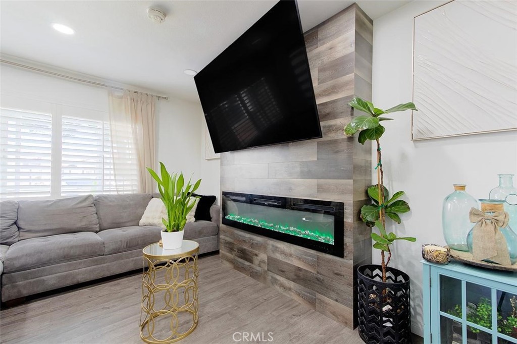 11523 Richeon Avenue Downey, CA 90241 - Photo 6 of 25 a living room with furniture fireplace and potted plant