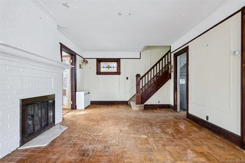 a view of a livingroom with a fireplace and stairs