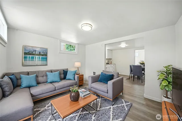 a living room with furniture potted plant and a table