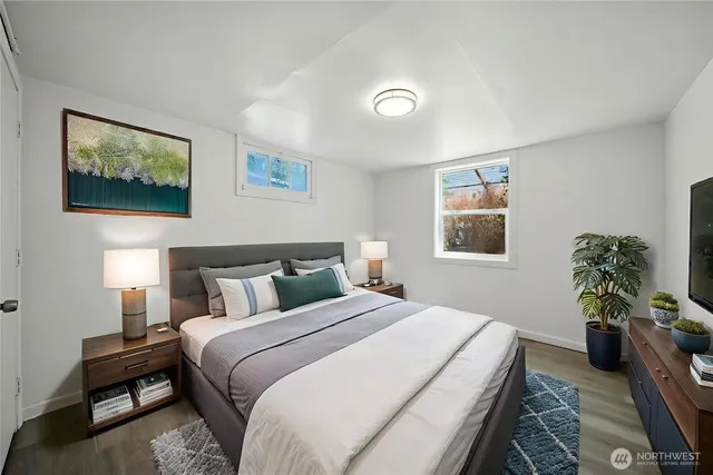 a bedroom with bed and a potted plant