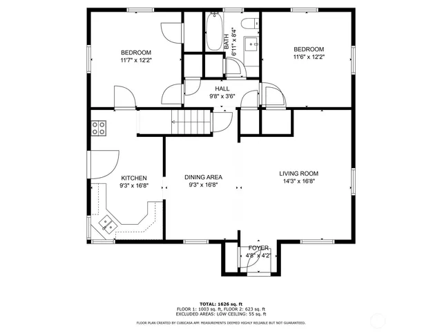 a picture of a bench in front of a gate