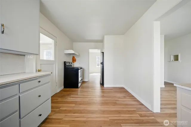 a view of a kitchen with wooden floor