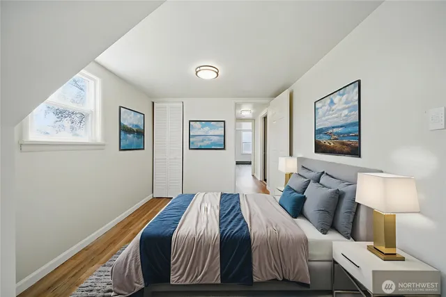 a bedroom with a bed and wall painting