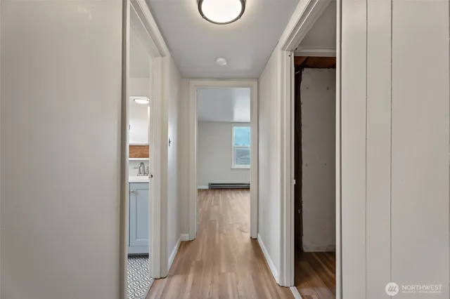 a view of hallway with wooden floor
