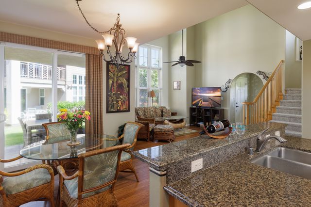 a view of a dining room with furniture and chandelier