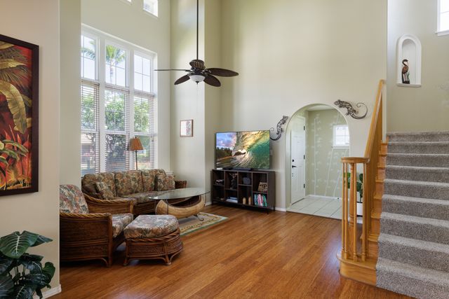 a living room with furniture and wooden floor