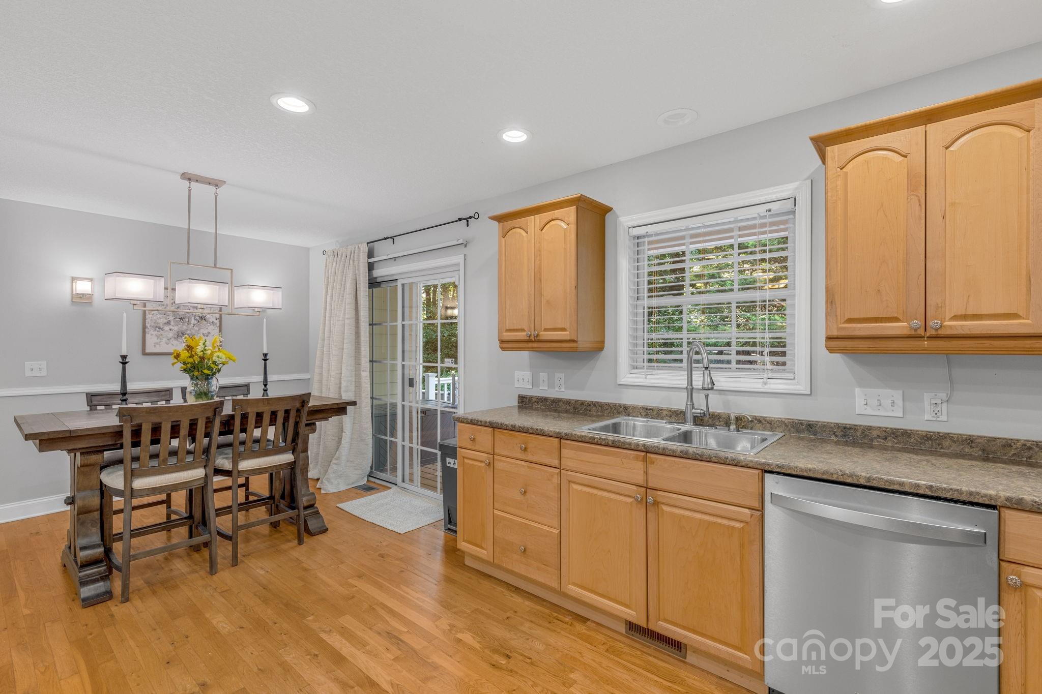 904 Mills Gap Road Fletcher, NC 28732 - Photo 12 of 36 a kitchen with granite countertop a sink dining table and chairs