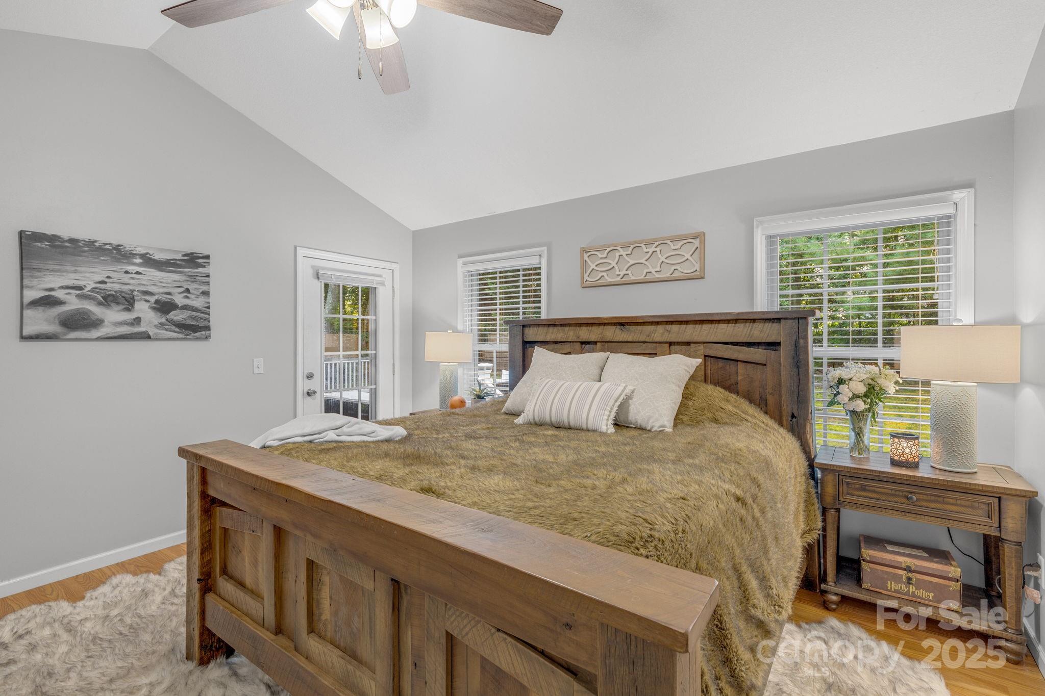 904 Mills Gap Road Fletcher, NC 28732 - Photo 14 of 36 a bedroom with a bed and a chandelier