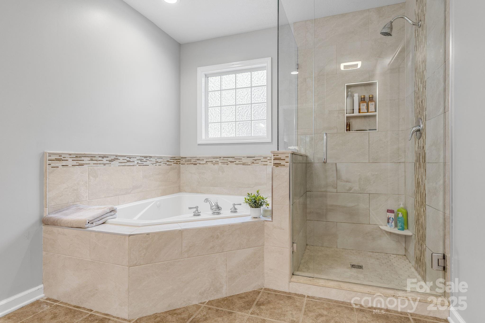 904 Mills Gap Road Fletcher, NC 28732 - Photo 17 of 36 a bathroom with a bathtub and shower