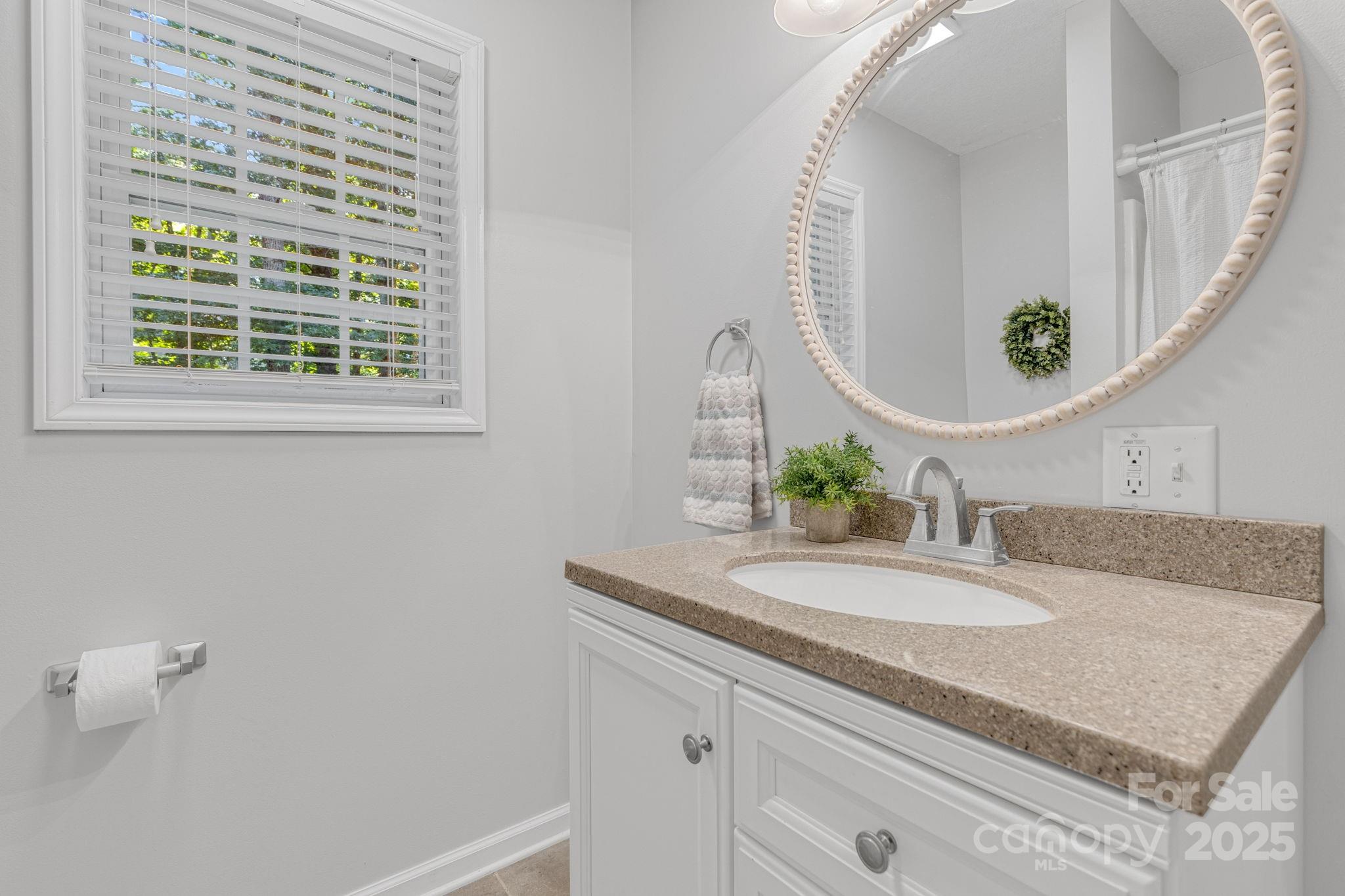 904 Mills Gap Road Fletcher, NC 28732 - Photo 22 of 36 a bathroom with a granite countertop sink and a mirror