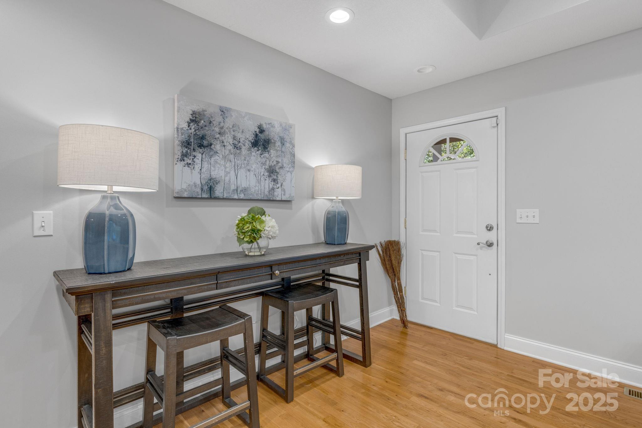 904 Mills Gap Road Fletcher, NC 28732 - Photo 4 of 36 a view of a workspace room with wooden floor and table