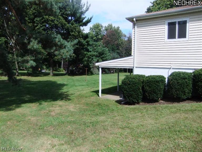 10515 Johnnycake Ridge Road Painesville, OH 44077 - Photo 3 of 10 Side view of home. The covered patio makes a great place for outdoor entertaining.