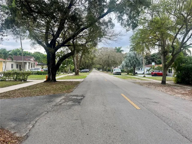 a view of street with parked cars