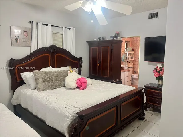 a bedroom with a bed and a flat screen television