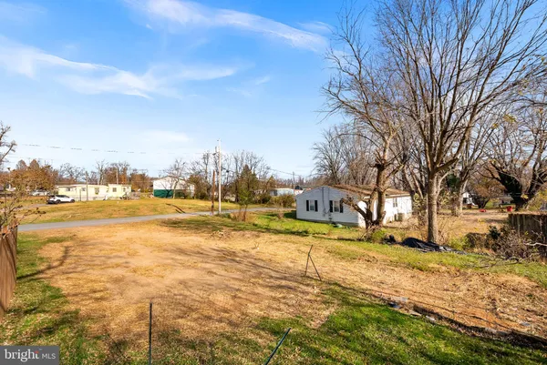 a view of yard with swimming pool and trees