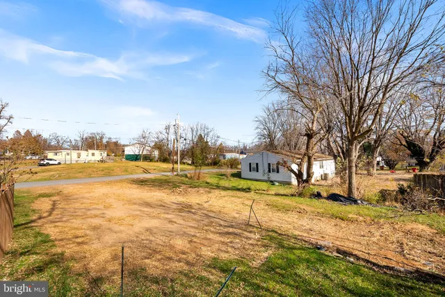 a view of yard with swimming pool and trees