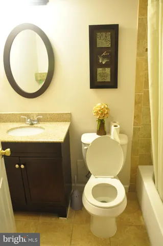 a bathroom with a toilet a sink and a mirror