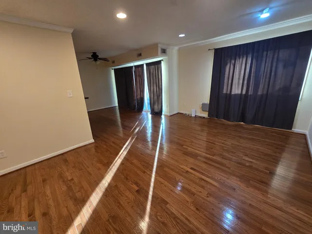 a view of hallway with wooden floor
