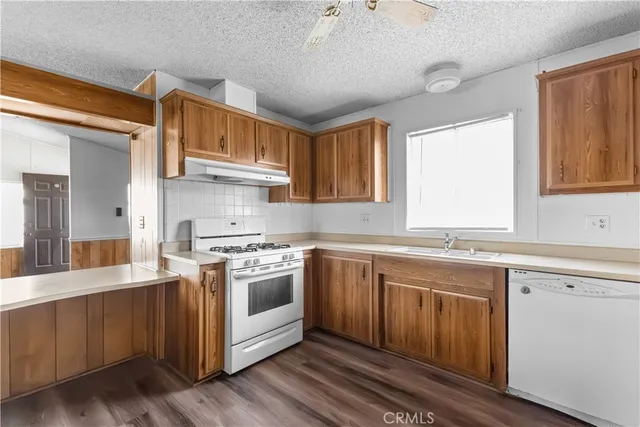 a kitchen with stainless steel appliances granite countertop a sink and cabinets
