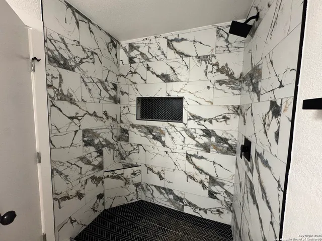 a bathroom with a bathtub and shower