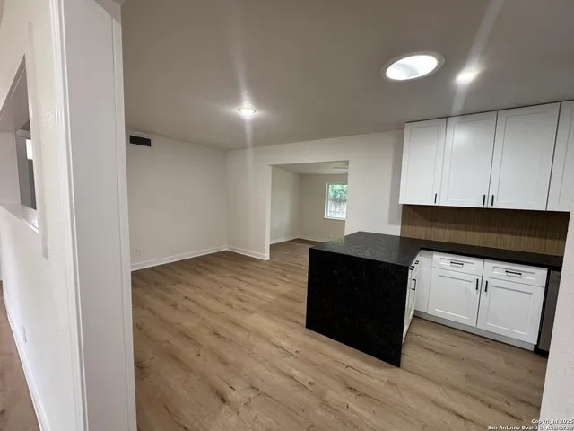 a kitchen with granite countertop a refrigerator and a stove