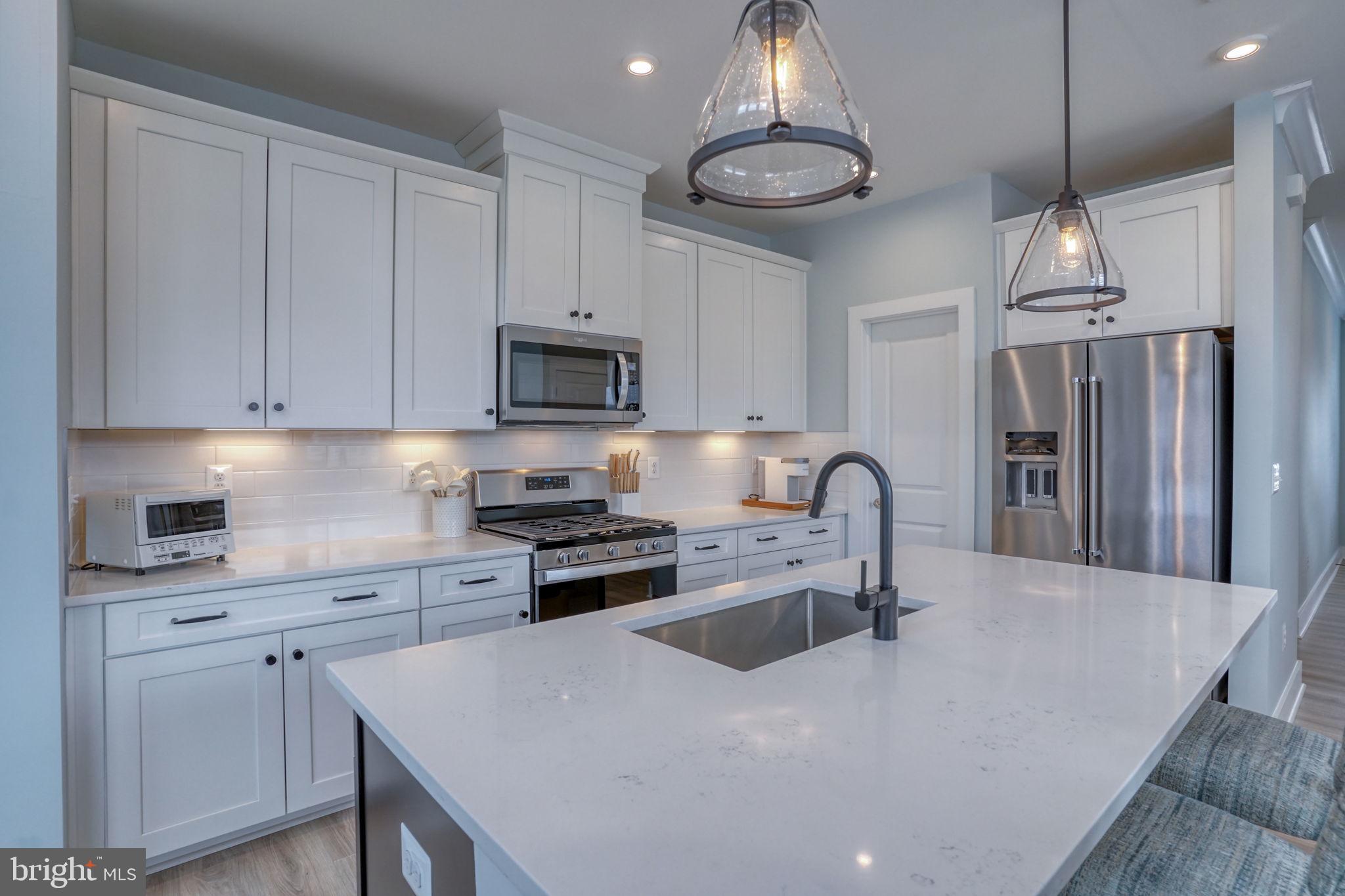 266 Exeter Street Ocean View, DE 19970 - Photo 10 of 62 a large kitchen with stainless steel appliances granite countertop a stove a sink a refrigerator and a stove