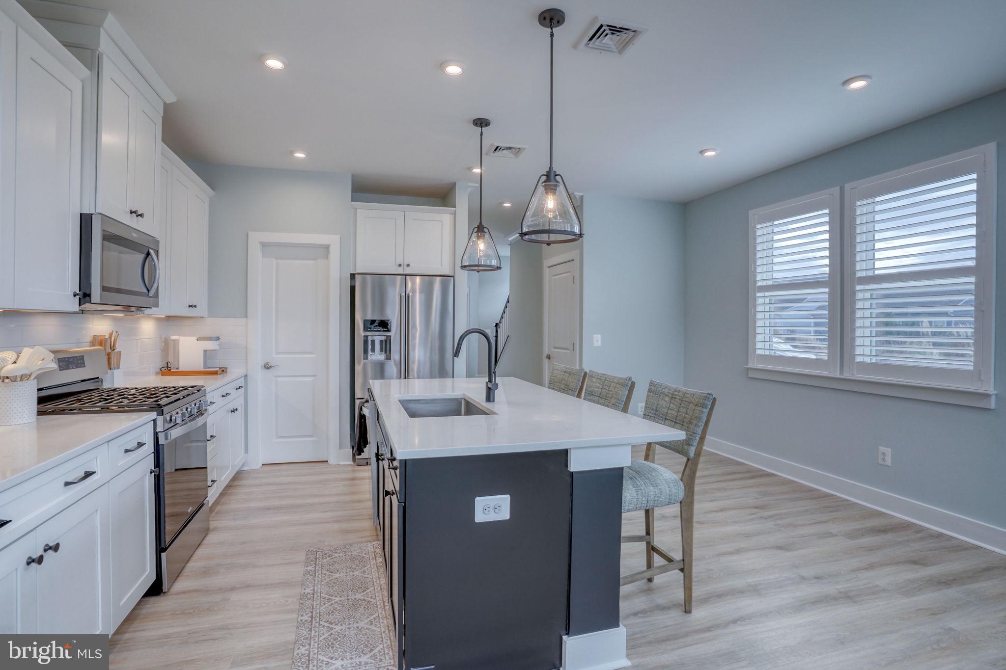 266 Exeter Street Ocean View, DE 19970 - Photo 12 of 62 a large kitchen with stainless steel appliances a large center island attached withe living room
