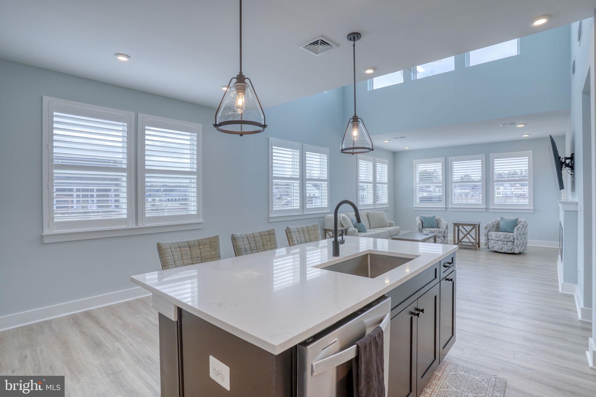 266 Exeter Street Ocean View, DE 19970 - Photo 60 of 62 a kitchen with center island a sink appliances and a wooden floor