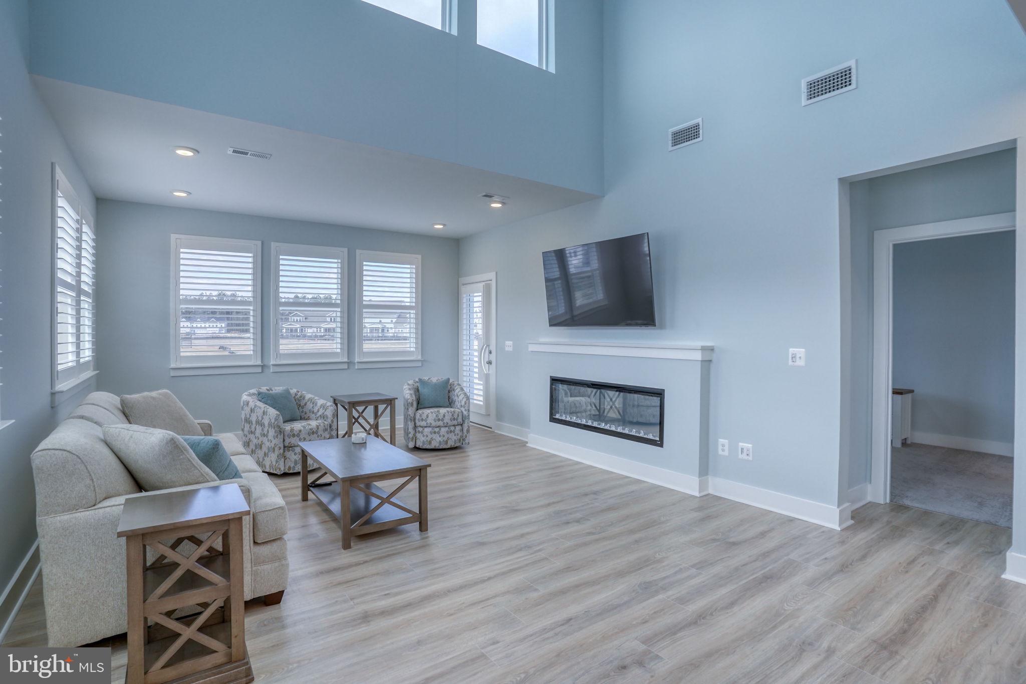 266 Exeter Street Ocean View, DE 19970 - Photo 13 of 62 a living room with furniture a fireplace and a flat screen tv