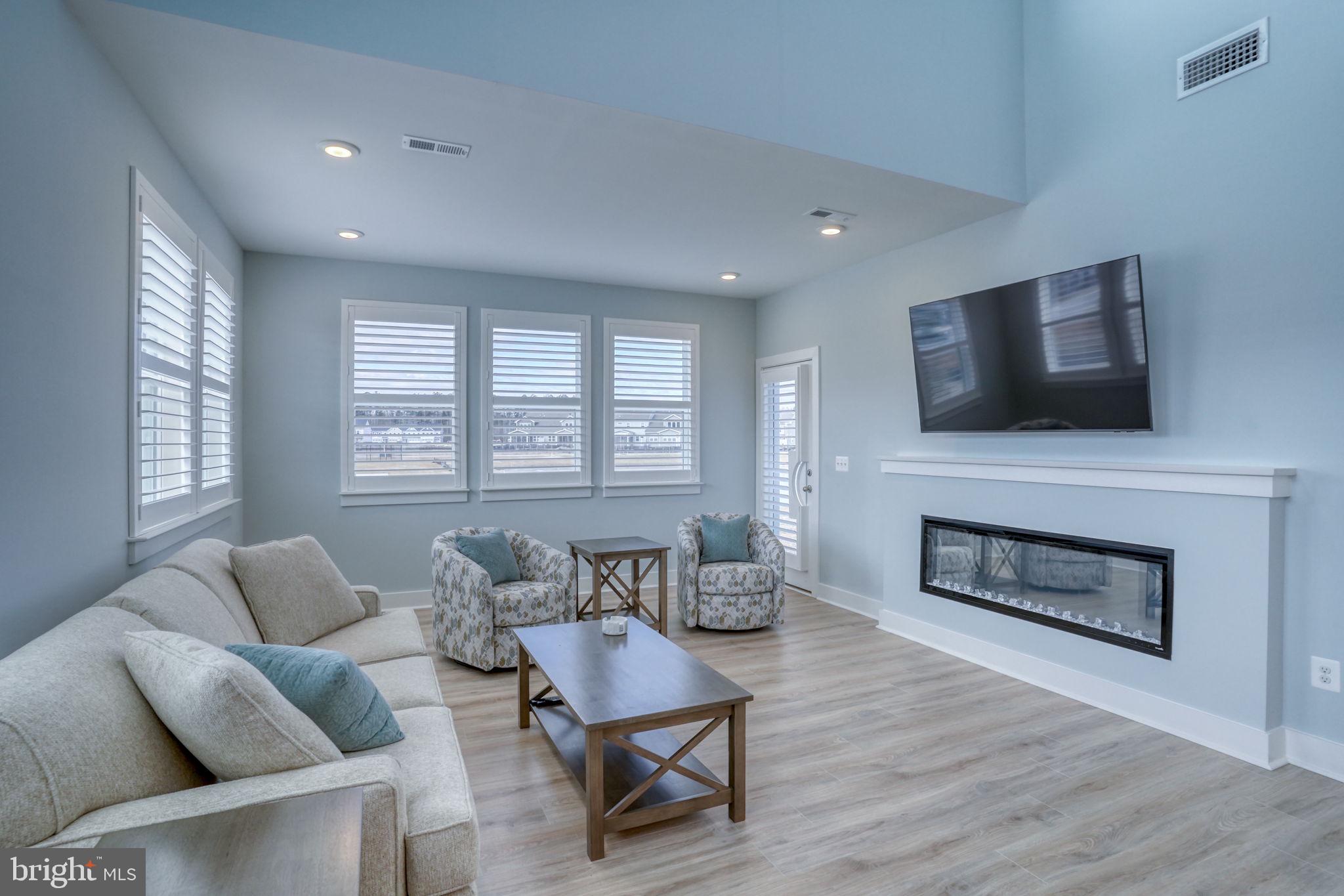 266 Exeter Street Ocean View, DE 19970 - Photo 14 of 62 a living room with furniture a flat screen tv and a fireplace