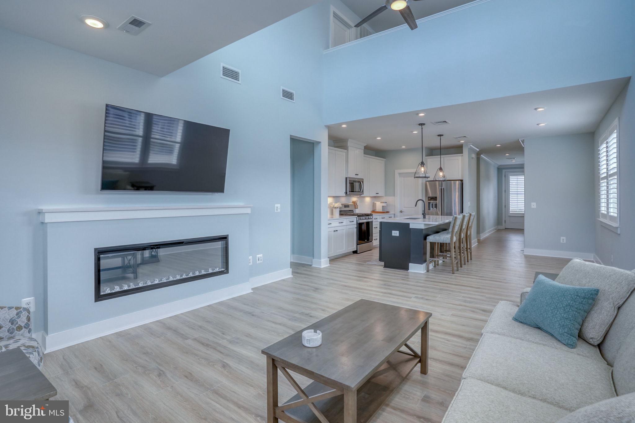 266 Exeter Street Ocean View, DE 19970 - Photo 16 of 62 a living room with furniture a fireplace and a flat screen tv