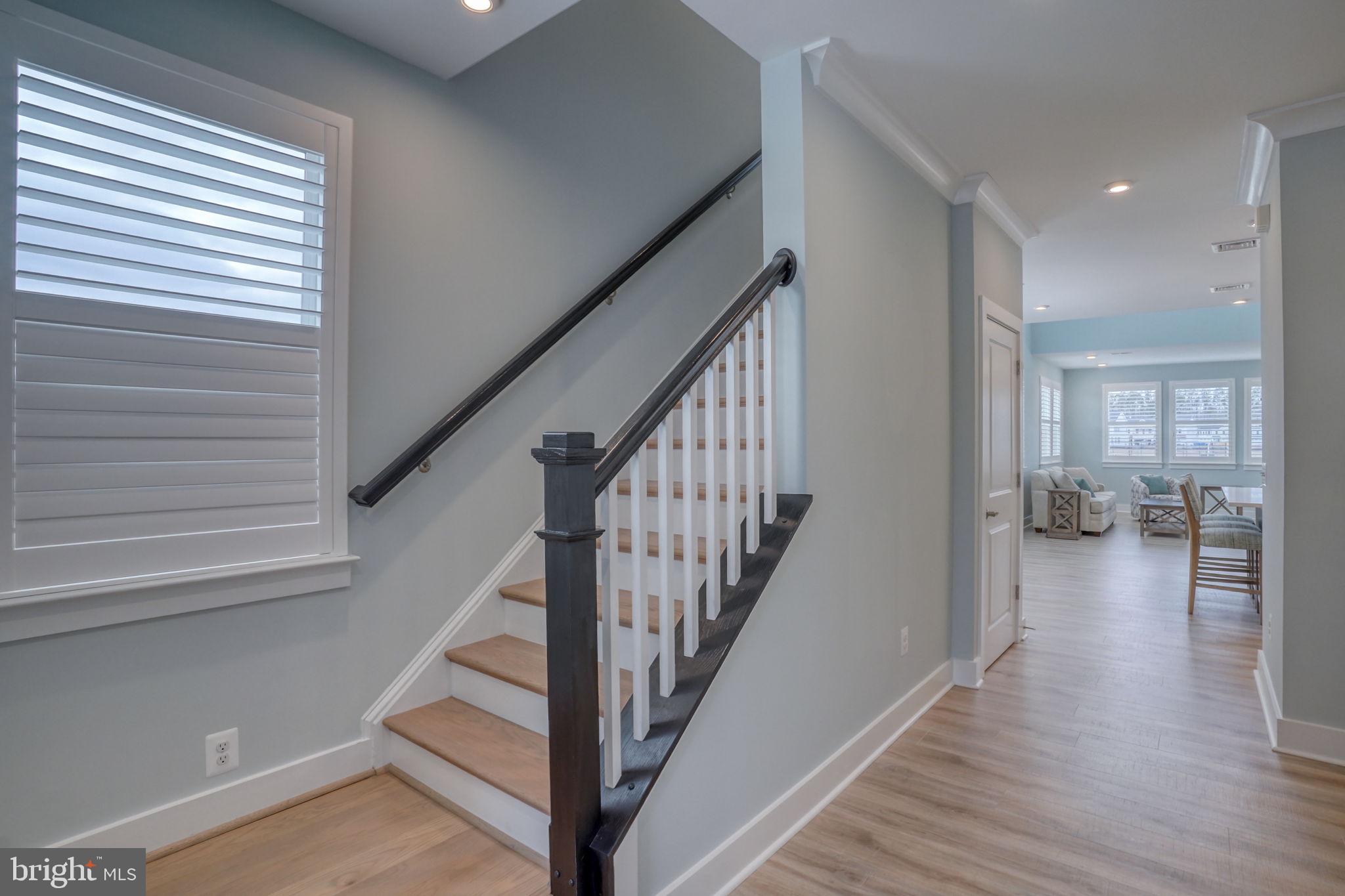 266 Exeter Street Ocean View, DE 19970 - Photo 18 of 62 a view of a hallway with wooden floor staircase and a living room