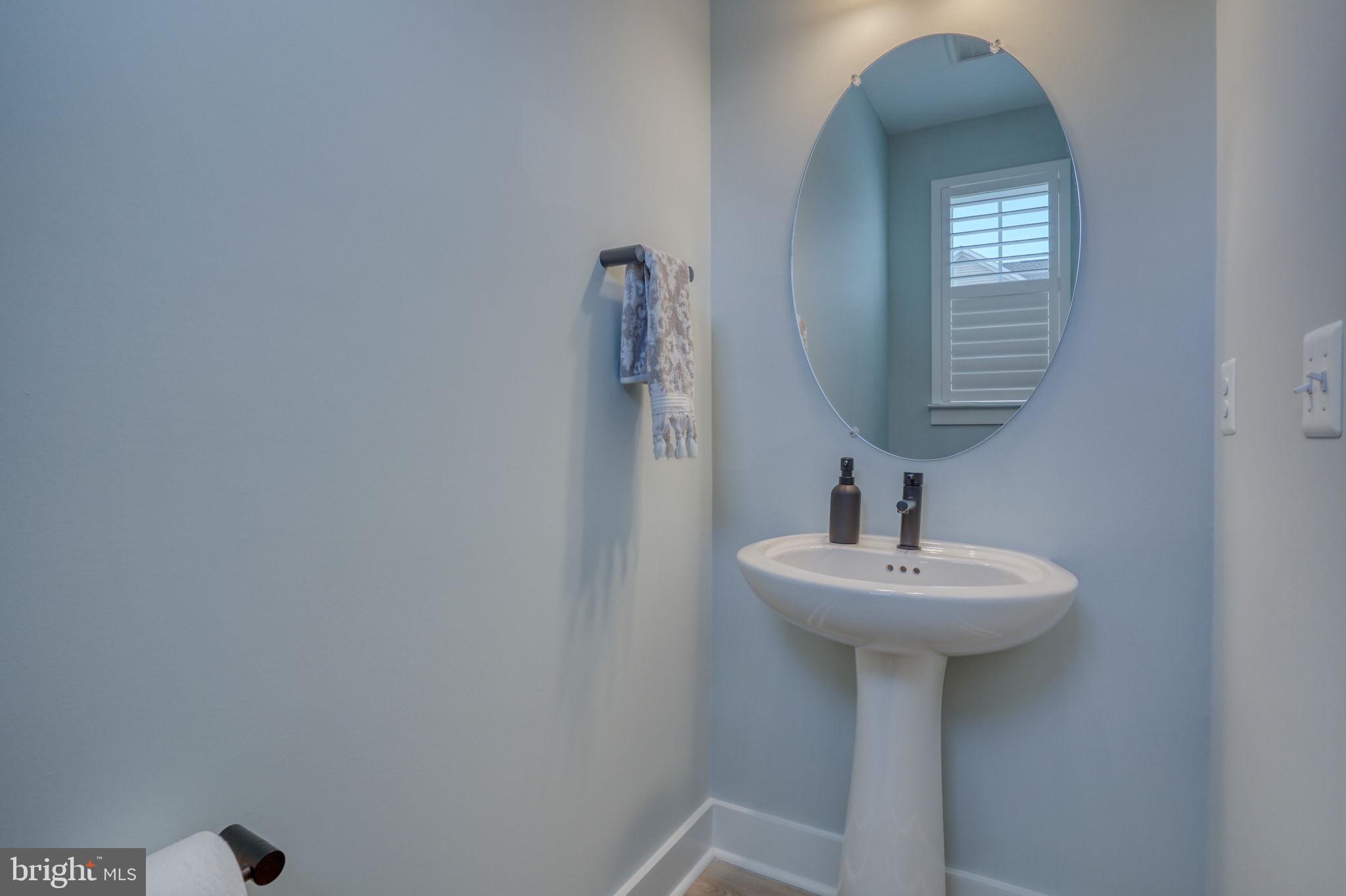 266 Exeter Street Ocean View, DE 19970 - Photo 19 of 62 a bathroom with a sink a mirror and vanity