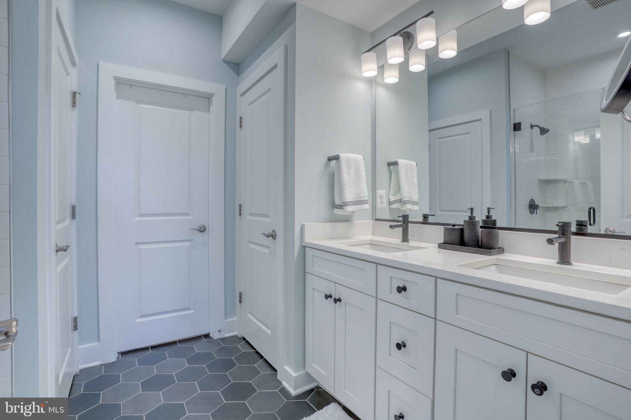 266 Exeter Street Ocean View, DE 19970 - Photo 22 of 62 a bathroom with a double vanity sink and a mirror