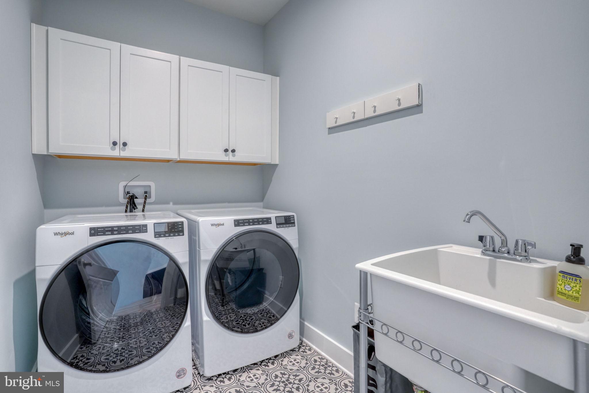 266 Exeter Street Ocean View, DE 19970 - Photo 32 of 62 a utility room with sink dryer and washer