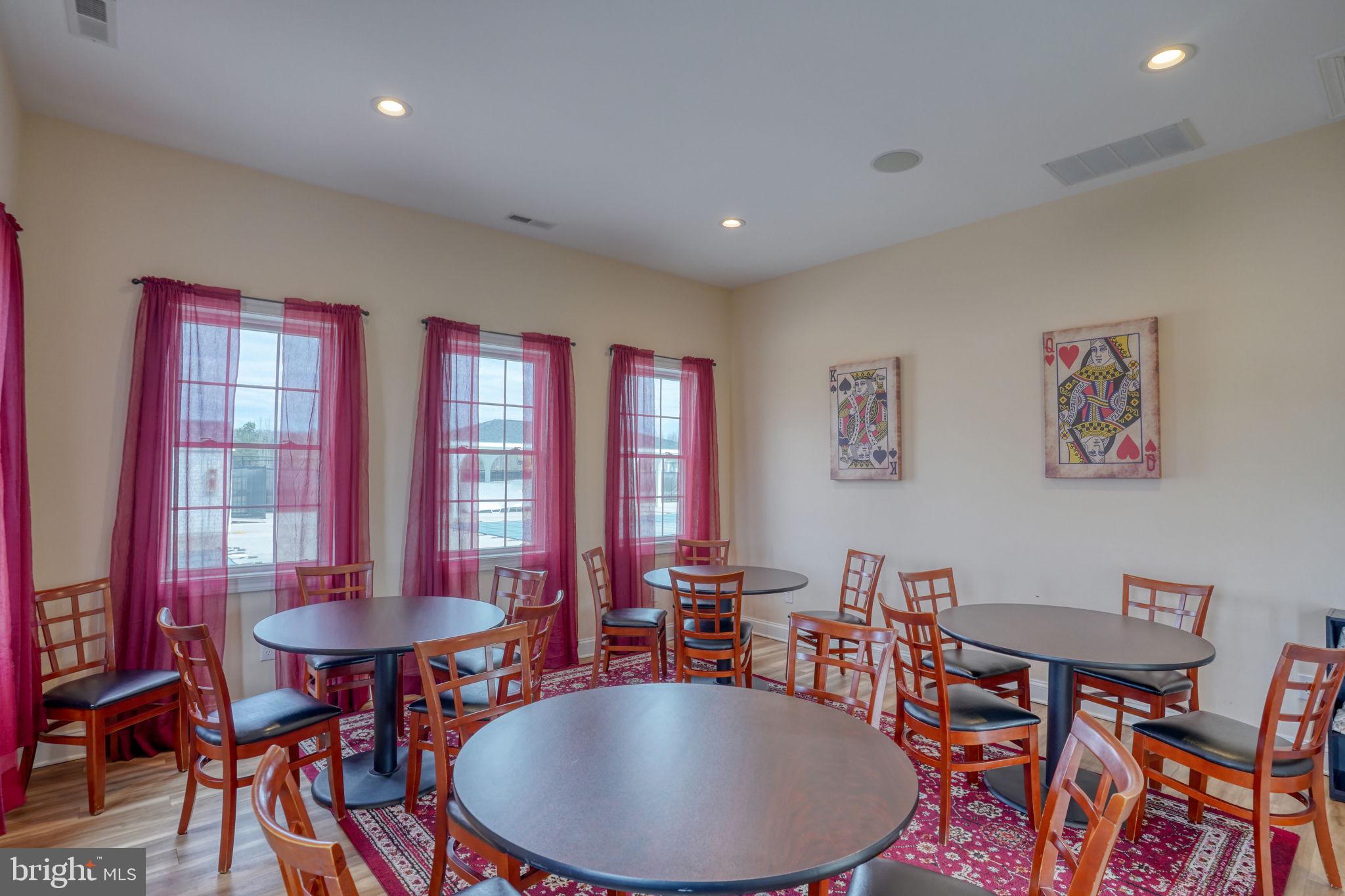 266 Exeter Street Ocean View, DE 19970 - Photo 39 of 62 a dining room with furniture a rug and a chandelier