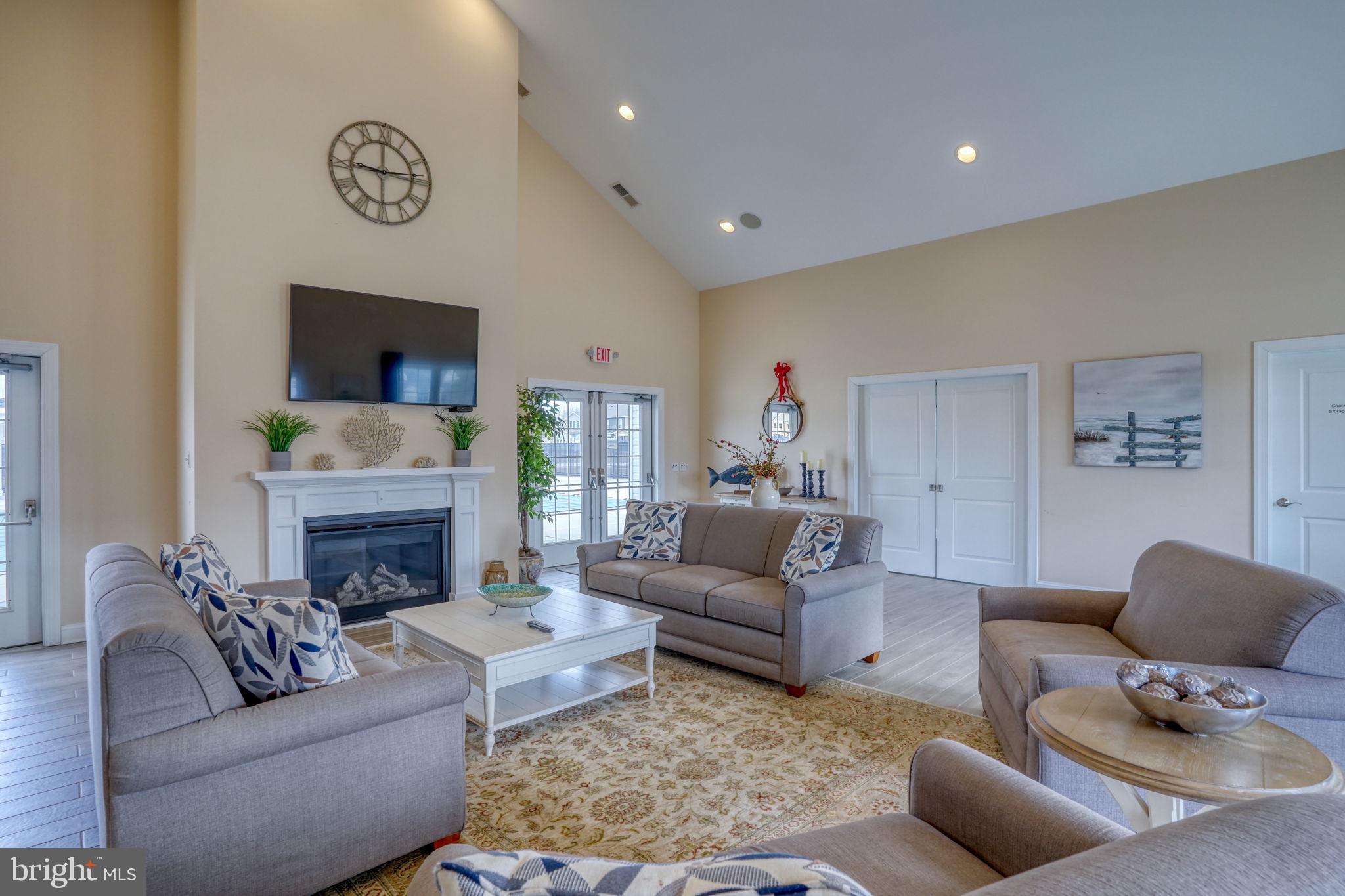 266 Exeter Street Ocean View, DE 19970 - Photo 40 of 62 a living room with furniture a fireplace and a flat screen tv