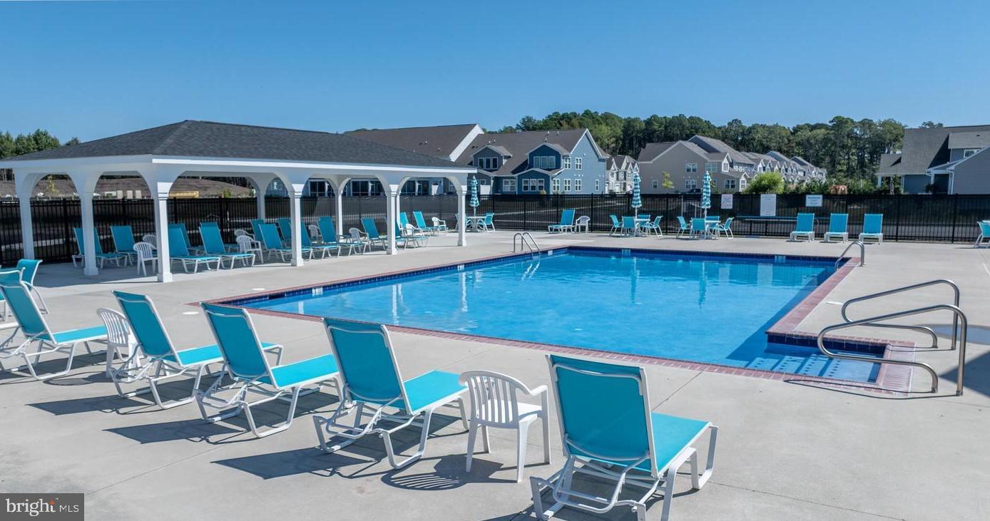 266 Exeter Street Ocean View, DE 19970 - Photo 49 of 62 a view of a patio with table and chairs near a barbeque