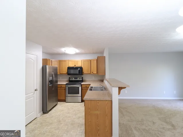 a kitchen with refrigerator and stove