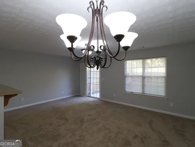 a view of a room with windows and chandelier