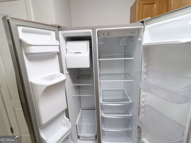 a view of walk in closet with empty racks