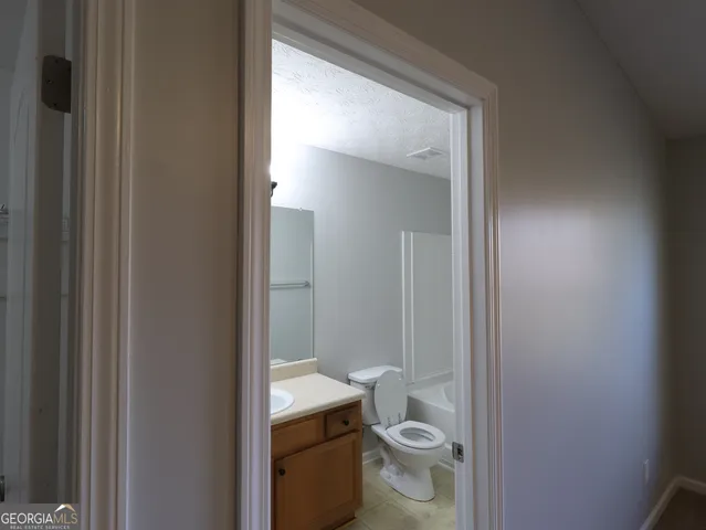 a white toilet sitting next to a shower