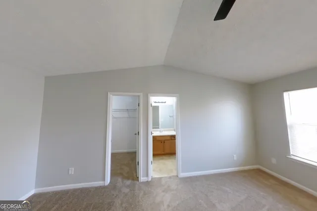 an empty room with windows and closet
