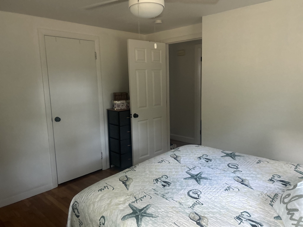 48 Smiths Lane Kingston, MA 02364 - Photo 12 of 22 a bedroom with a bed and a chandelier