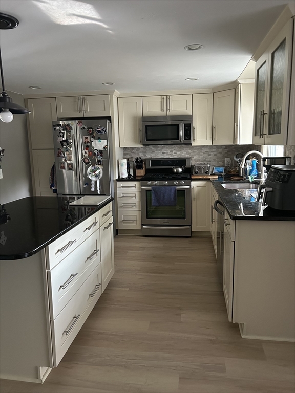 48 Smiths Lane Kingston, MA 02364 - Photo 10 of 22 a kitchen with stainless steel appliances kitchen island granite countertop a refrigerator and a stove top oven