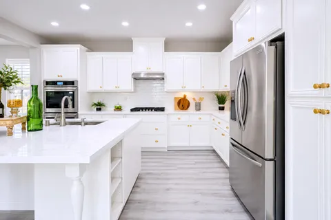 a kitchen with stainless steel appliances a refrigerator sink and microwave