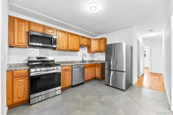 a kitchen with a refrigerator and a stove