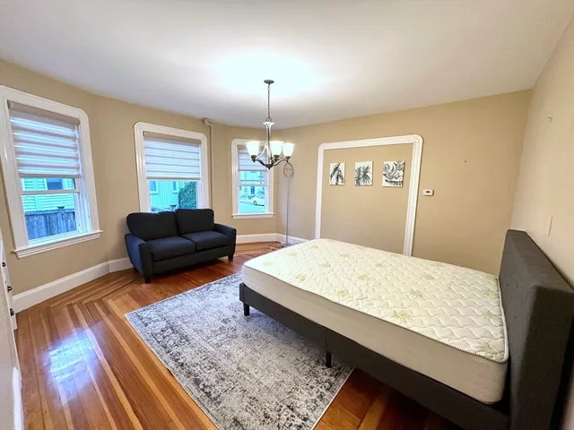 a bedroom with a bed window and couch