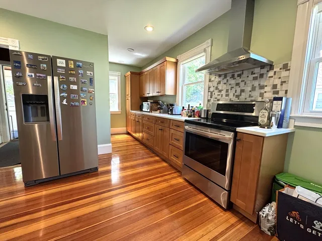 a kitchen with stainless steel appliances a stove top oven and refrigerator